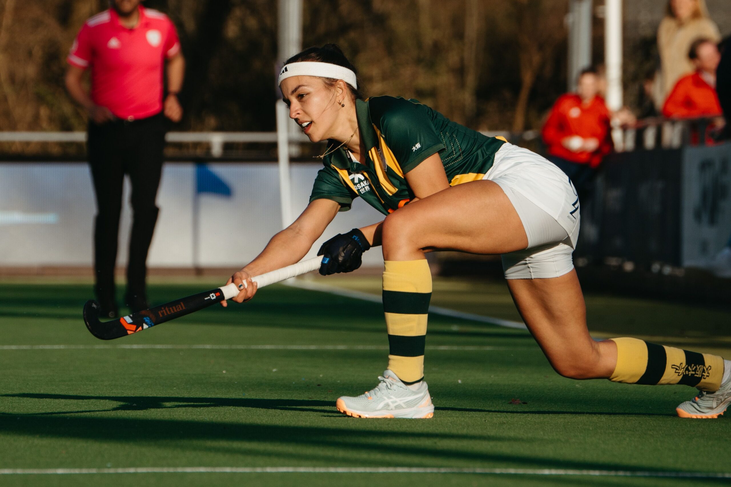 Two field hockey players competing for the ball