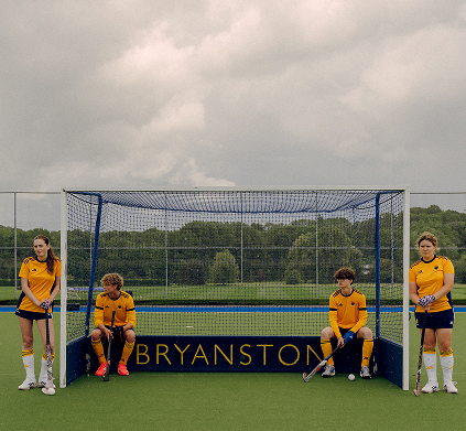 Field hockey players at a goal