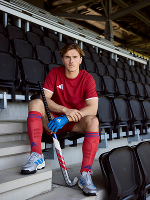 Field hockey player seated in stadium seating